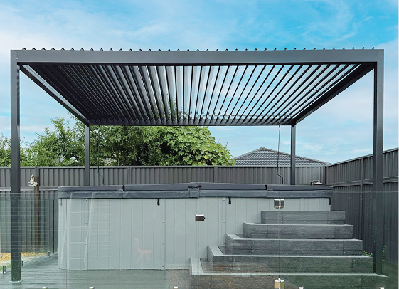 Black louvre roof pergola installed over outdoor spa in modern residential backyard